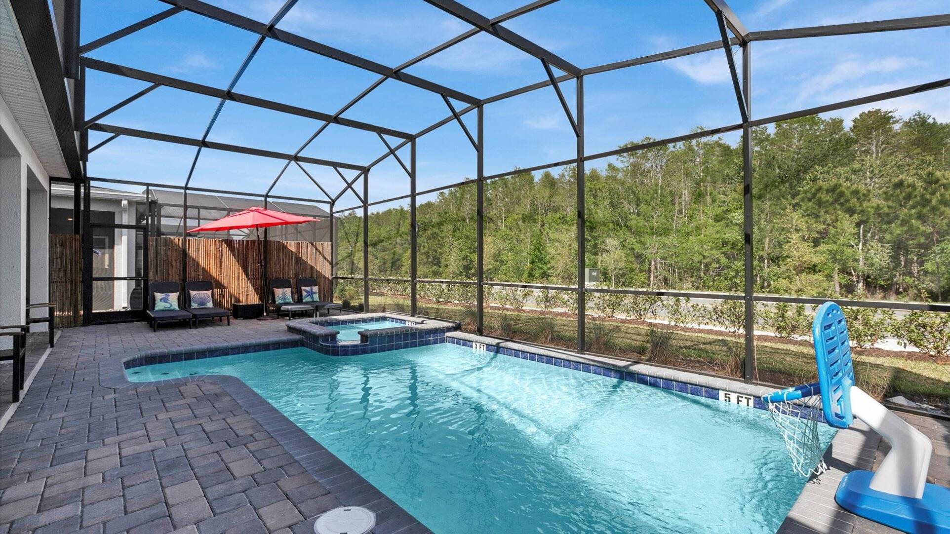 Private screened pool with sun loungers and spa at a Storey Lake Resort villa Kissimmee Orlando