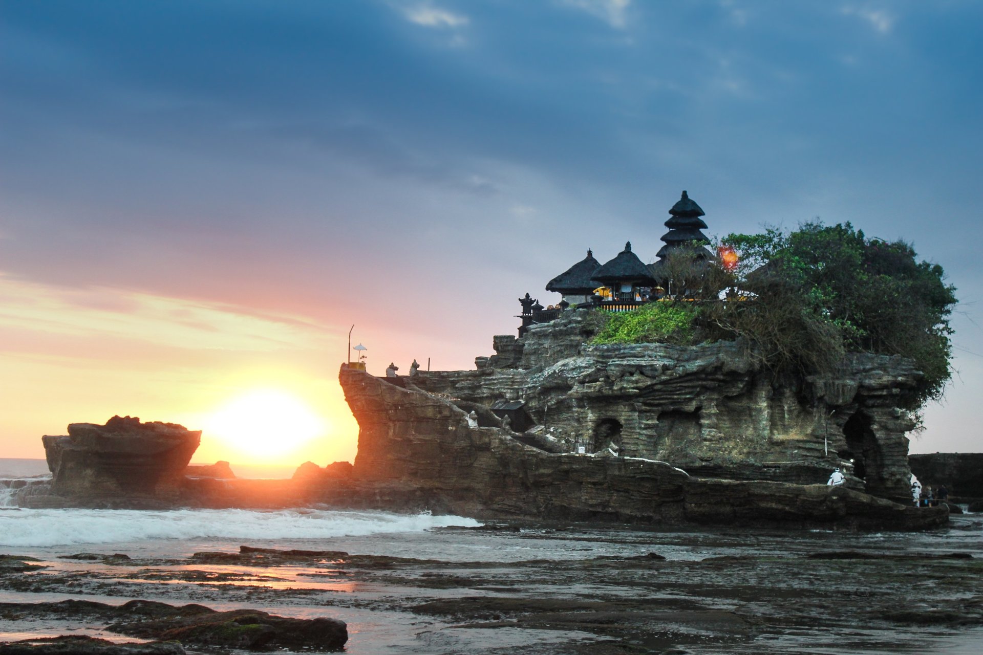 Tanah Lot sea temple perched on a coastal rock at sunset in Bali, Indonesia